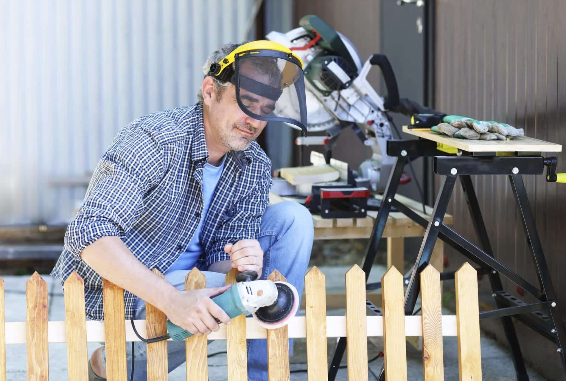 Portrait Of A Handyman Making A Fence 2023 11 27 05 07 16 Utc 1 Scaled Types Of Fences Including Wood, Metal, And Chain Link Examples